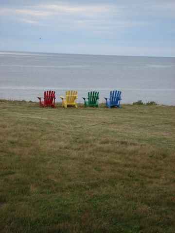Sit by the ocean on the coloured muskoka chairs